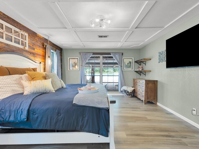 bedroom featuring visible vents, beam ceiling, baseboards, coffered ceiling, and light wood-style flooring
