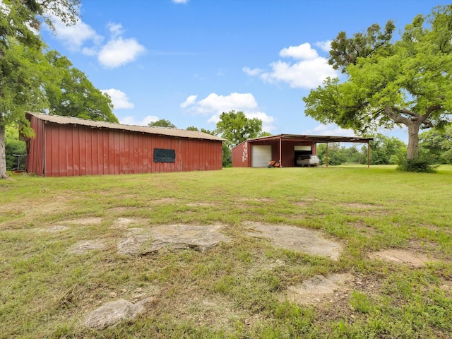 view of yard with an outbuilding, an outdoor structure, and a garage