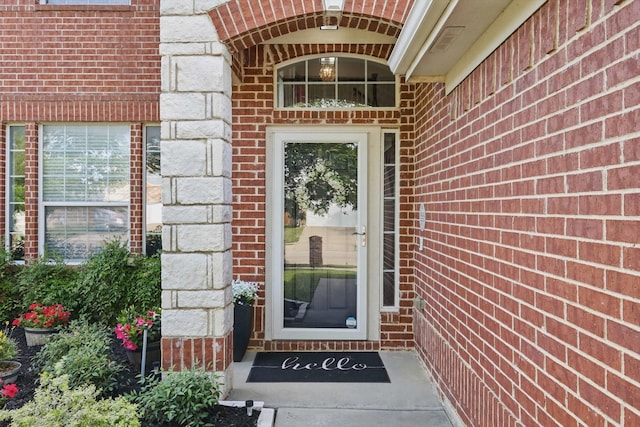 entrance to property featuring brick siding