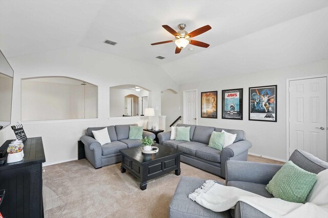 living area featuring a ceiling fan, visible vents, arched walkways, carpet floors, and lofted ceiling