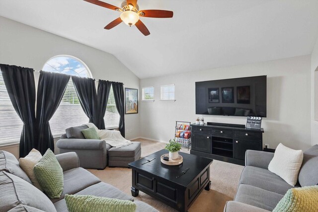 living room featuring baseboards, a ceiling fan, and vaulted ceiling