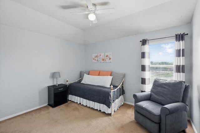 bedroom featuring a ceiling fan, baseboards, and light carpet