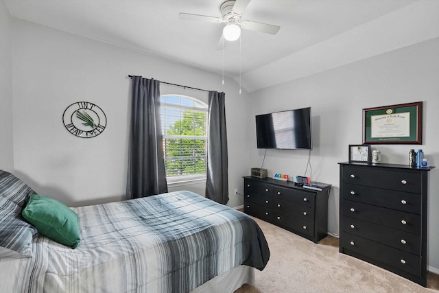 carpeted bedroom featuring ceiling fan and vaulted ceiling