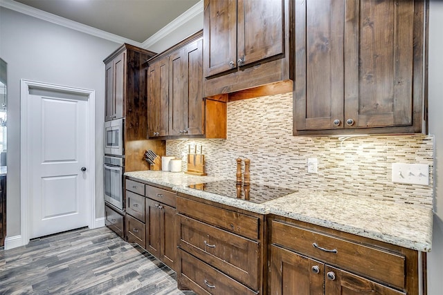 kitchen featuring crown molding, decorative backsplash, dark wood-type flooring, light stone counters, and appliances with stainless steel finishes