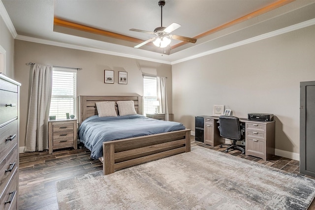 bedroom with a tray ceiling, ornamental molding, and wood finished floors