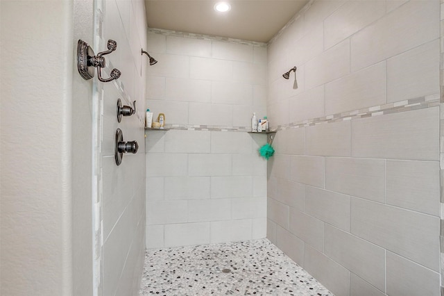 full bathroom with a tile shower and recessed lighting