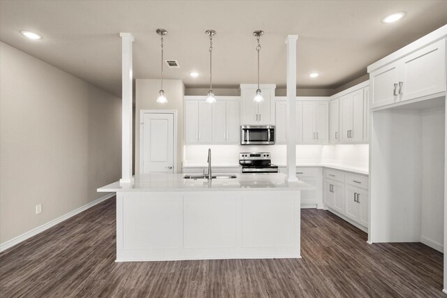 kitchen with dark wood-type flooring, a sink, white cabinetry, and appliances with stainless steel finishes