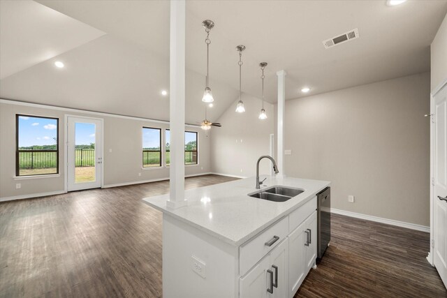 kitchen with lofted ceiling, open floor plan, ornate columns, a sink, and dishwasher