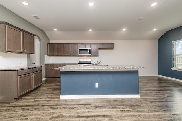 146 Willowbend Loop, Mabank, TX 75156 - kitchen featuring visible vents, dark wood-style flooring, appliances with stainless steel finishes, and a center island with sink