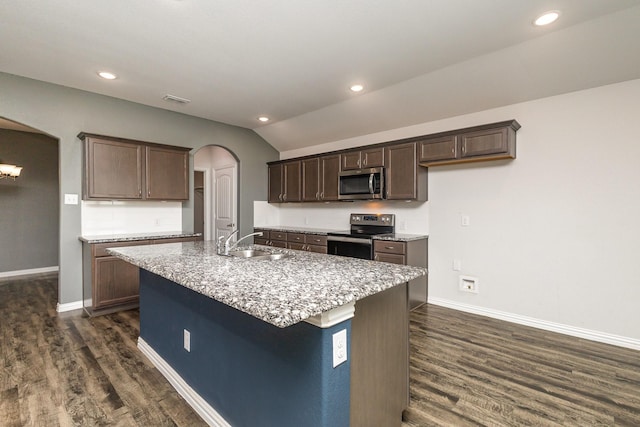 146 Willowbend Loop, Mabank, TX 75156 - kitchen with a sink, arched walkways, an island with sink, stainless steel appliances, and dark wood-type flooring