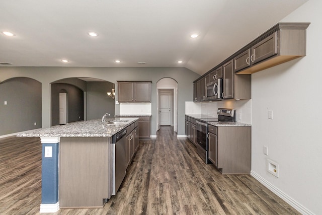 146 Willowbend Loop, Mabank, TX 75156 - kitchen with an island with sink, arched walkways, dark wood-style flooring, and appliances with stainless steel finishes