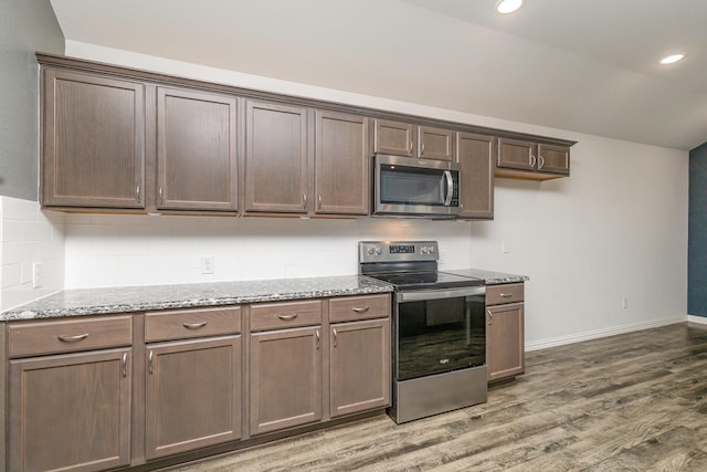 146 Willowbend Loop, Mabank, TX 75156 - kitchen featuring backsplash, appliances with stainless steel finishes, light stone countertops, baseboards, and light wood finished floors