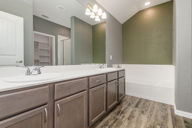 146 Willowbend Loop, Mabank, TX 75156 - full bathroom featuring a sink, a garden tub, a stall shower, and wood finished floors