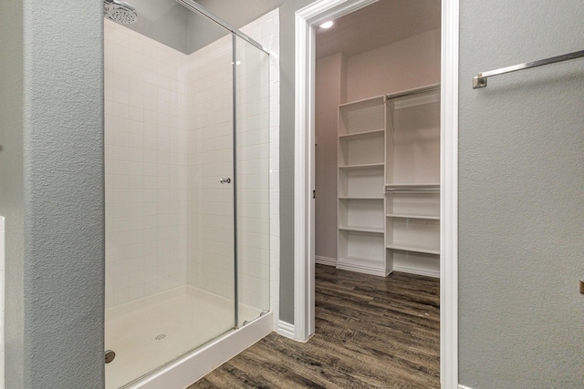 146 Willowbend Loop, Mabank, TX 75156 - bathroom featuring a textured wall, wood finished floors, and a stall shower
