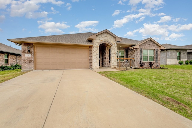 146 Willowbend Loop, Mabank, TX 75156 - view of front of property featuring an attached garage, brick siding, stone siding, a front yard, and driveway