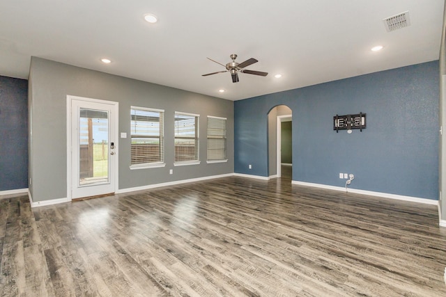 146 Willowbend Loop, Mabank, TX 75156 - unfurnished living room with ceiling fan, visible vents, arched walkways, wood finished floors, and baseboards