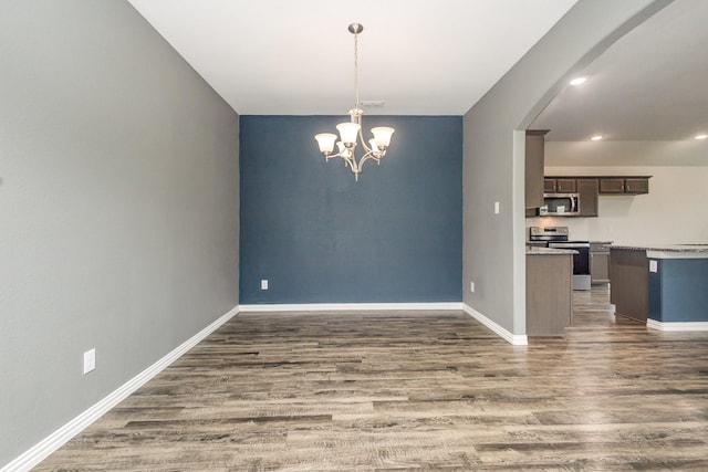 146 Willowbend Loop, Mabank, TX 75156 - interior space with an inviting chandelier, dark wood-style flooring, baseboards, light countertops, and stainless steel appliances