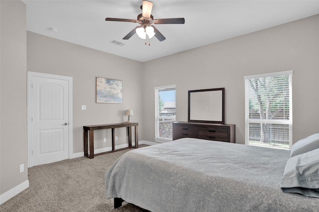bedroom featuring baseboards, carpet flooring, visible vents, and a ceiling fan