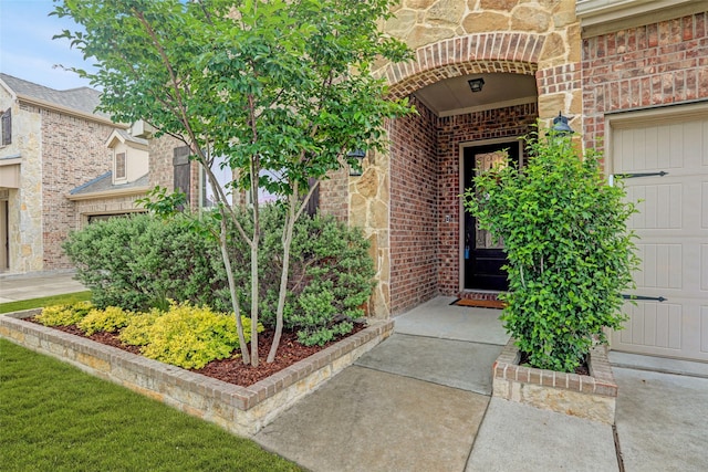 doorway to property featuring brick siding
