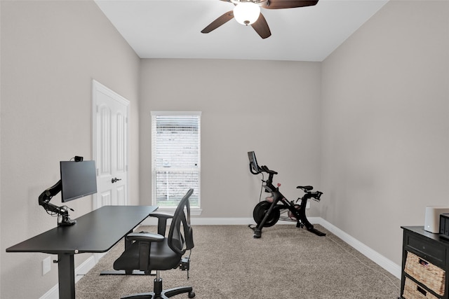 office area with a ceiling fan, baseboards, and carpet