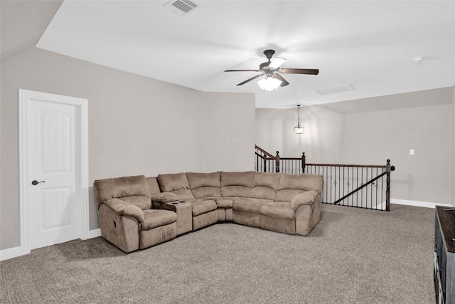 living area featuring ceiling fan, carpet, baseboards, and visible vents