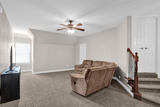 carpeted living room featuring vaulted ceiling, baseboards, and a ceiling fan