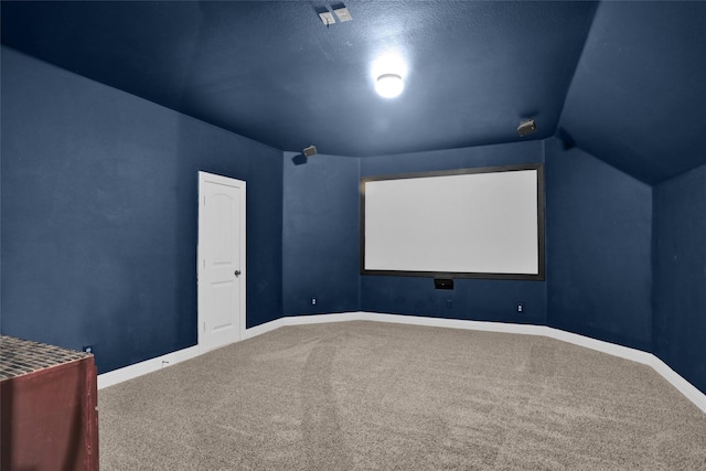 cinema featuring lofted ceiling, baseboards, and carpet floors