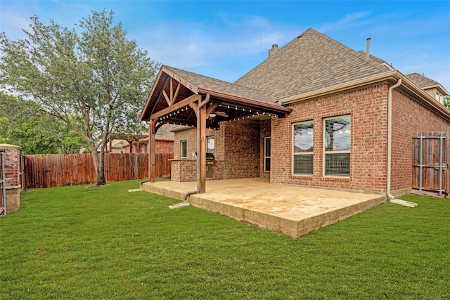 rear view of property with a patio area, brick siding, and roof with shingles