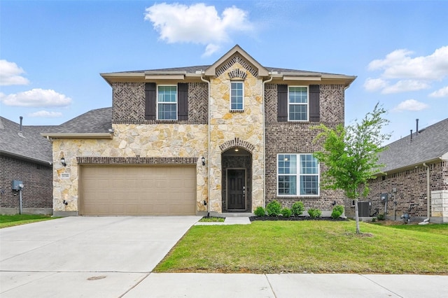 traditional-style house featuring central air condition unit, a front yard, driveway, and stone siding