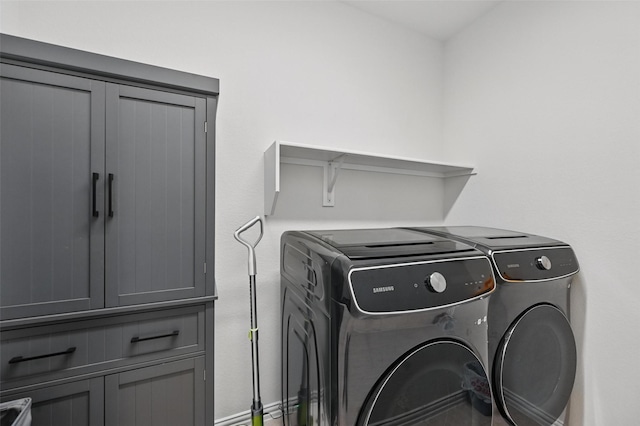 laundry room featuring cabinet space and washing machine and clothes dryer