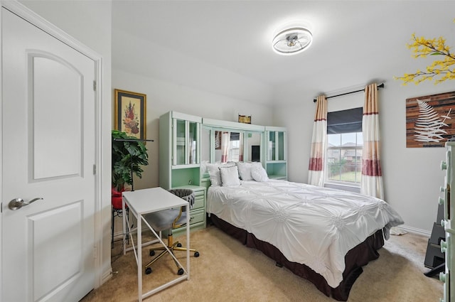 bedroom with baseboards and light carpet