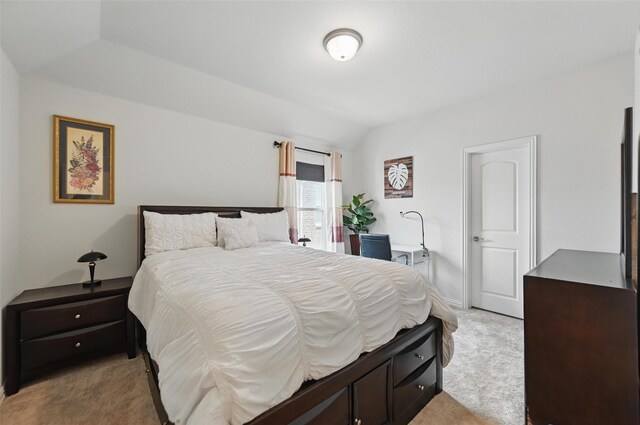 bedroom with light carpet and lofted ceiling