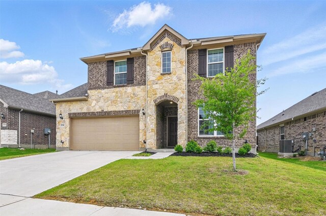 traditional home with a garage, a front yard, stone siding, central AC unit, and driveway