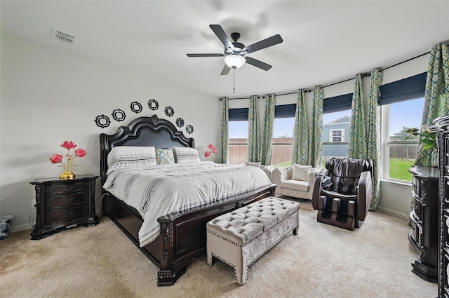 carpeted bedroom with visible vents, a ceiling fan, baseboards, and multiple windows