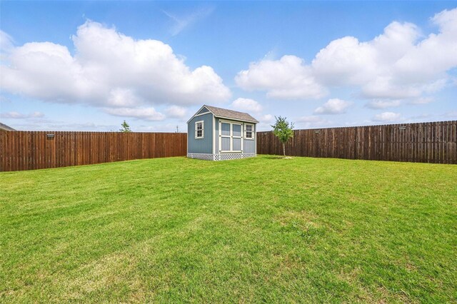 rear view of property with a fenced backyard, a yard, a patio area, and brick siding