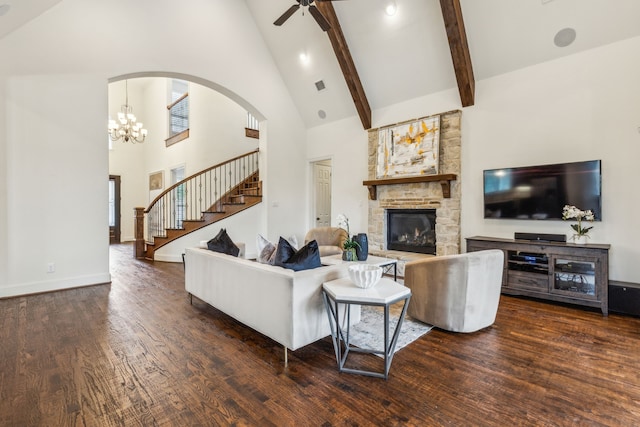 280 Gentry Dr, Prosper, TX 75078 - living room with high vaulted ceiling, a stone fireplace, ceiling fan with notable chandelier, stairs, and wood finished floors