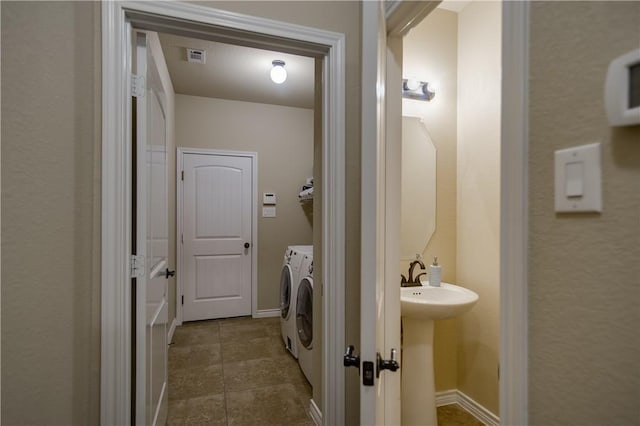 1290 Polo Heights Dr, Frisco, TX 75033 - clothes washing area with laundry area, visible vents, baseboards, dark tile patterned floors, and separate washer and dryer