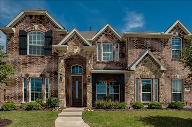 1290 Polo Heights Dr, Frisco, TX 75033 - view of front of property featuring stone siding, a front lawn, and brick siding