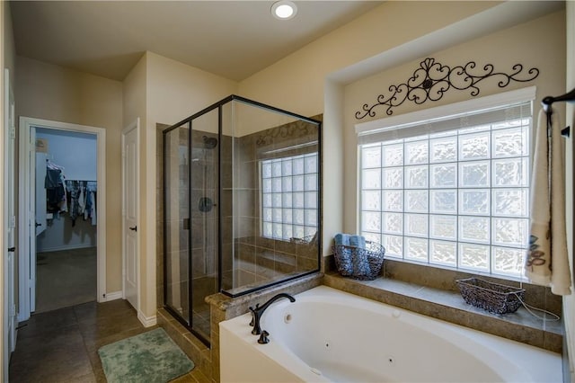 1290 Polo Heights Dr, Frisco, TX 75033 - bathroom featuring a jetted tub, a walk in closet, tile patterned flooring, a stall shower, and baseboards