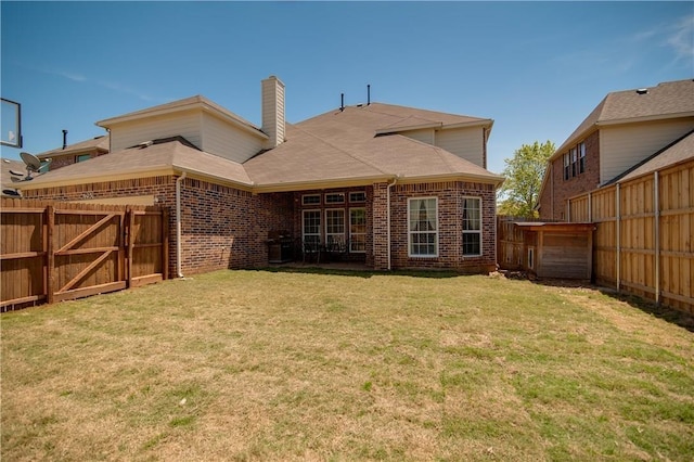 1290 Polo Heights Dr, Frisco, TX 75033 - back of house with brick siding, a fenced backyard, a yard, and a chimney