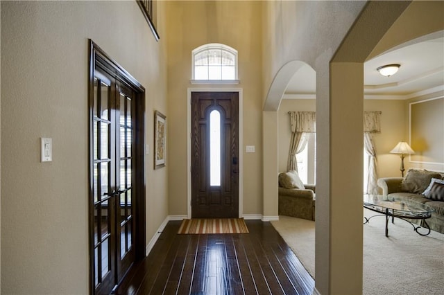 1290 Polo Heights Dr, Frisco, TX 75033 - foyer entrance with baseboards, dark wood finished floors, and arched walkways