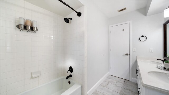 full bathroom featuring shower / bathtub combination, tile patterned floors, visible vents, and a sink