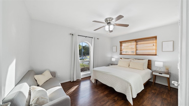 bedroom with a ceiling fan, baseboards, and wood finished floors