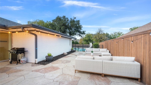 view of patio featuring area for grilling, an outdoor living space, and a fenced backyard