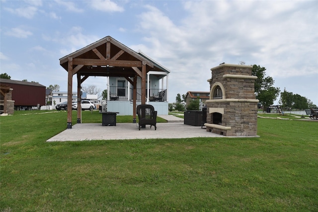 view of patio with a gazebo and a fireplace