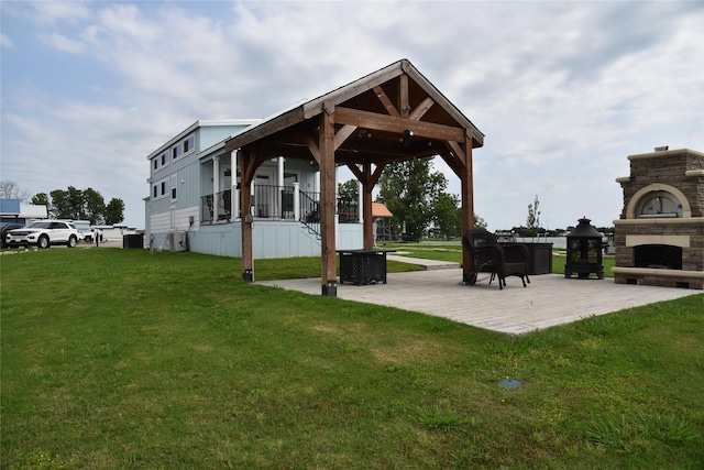 view of property's community featuring a lawn, a patio area, and a gazebo