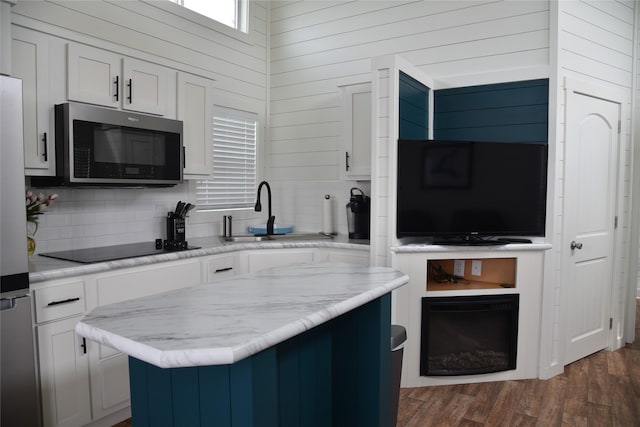 kitchen with white cabinetry, appliances with stainless steel finishes, and tasteful backsplash