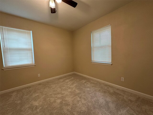 unfurnished room featuring baseboards, carpet, and ceiling fan
