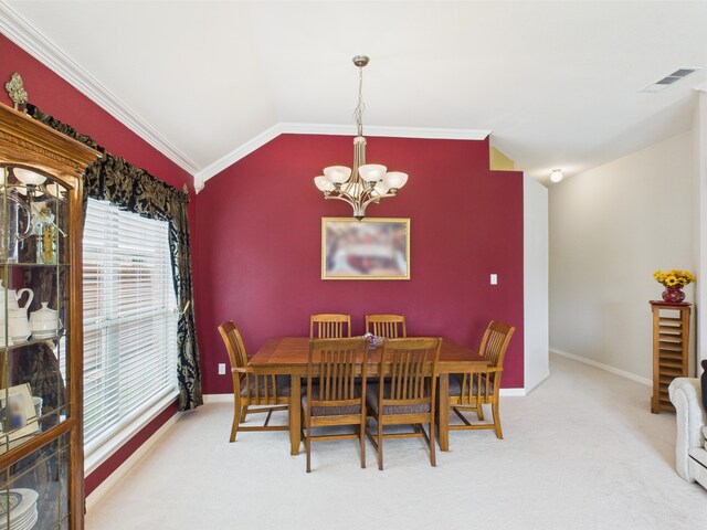 dining space with an inviting chandelier, visible vents, lofted ceiling, baseboards, and carpet flooring