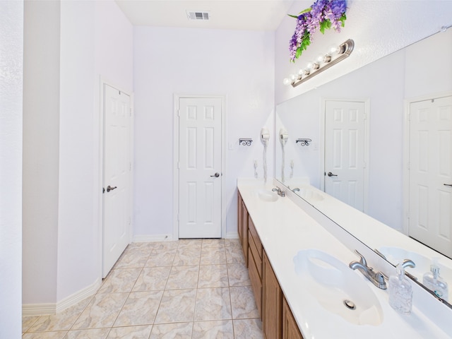 733 Willow Crest Dr, Midlothian, TX 76065 - full bathroom with double vanity, marble look tiles, and baseboards